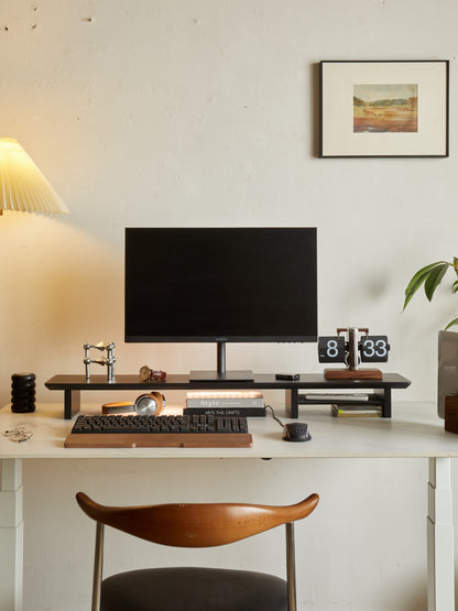 desk workspace with a black desk shelf